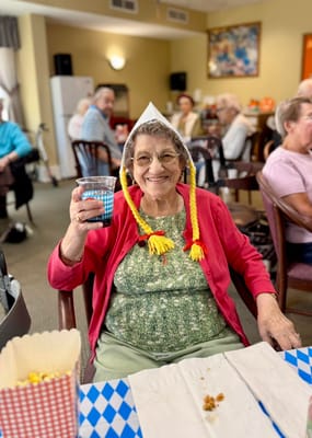 Resident celebrating with a drink during an activity