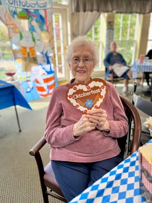 Resident celebrating Oktoberfest with a festive sign