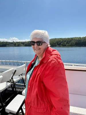 Smiling senior woman outdoors by the water