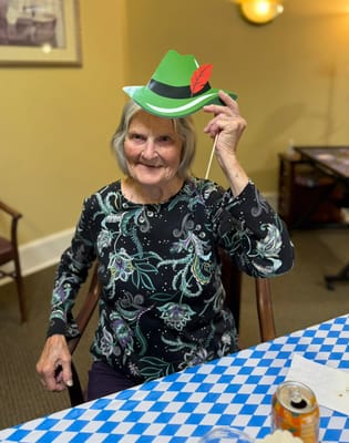 Senior resident in a festive hat during an activity