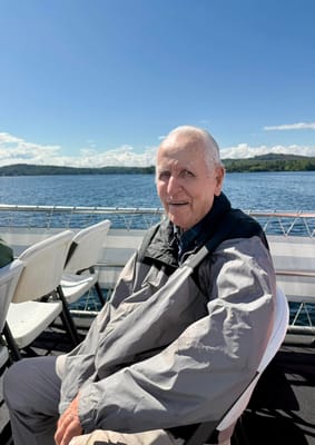 Smiling elderly man enjoying a scenic boat ride
