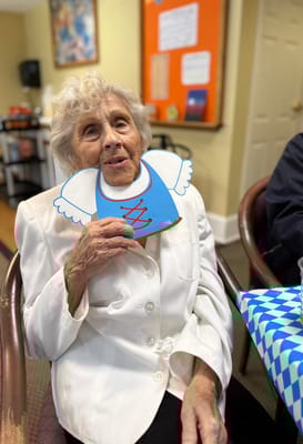Elderly woman with a playful decoration in an activity room