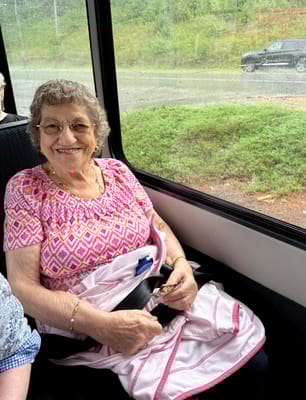 Senior resident sitting in a transport vehicle