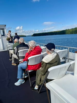 Seniors enjoying a boat ride on a sunny day