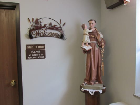 An interior space with a welcome sign and statue