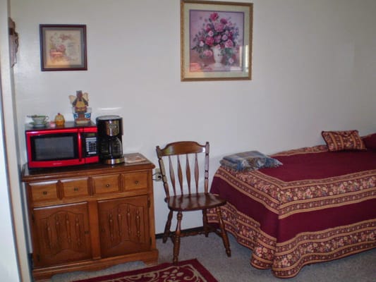 Cozy resident room with bed and furniture