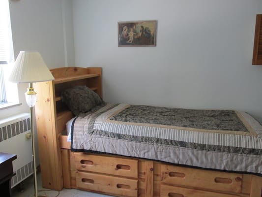 Cozy resident room with a bed and lamp