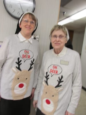 Staff members in fun holiday-themed sweaters