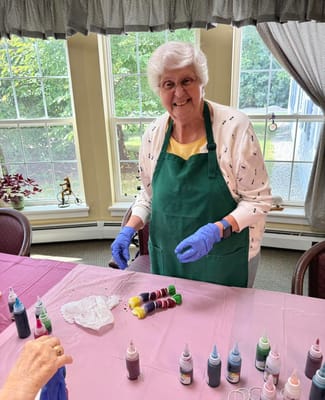 Resident participating in a creative activity with paint.