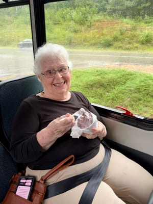 Senior resident enjoying ice cream on a bus