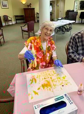 Resident engaging in a creative activity with paint