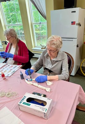 Residents engaged in a craft activity at a table