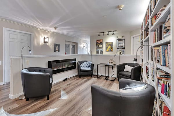 Cozy common area with bookshelves and seating