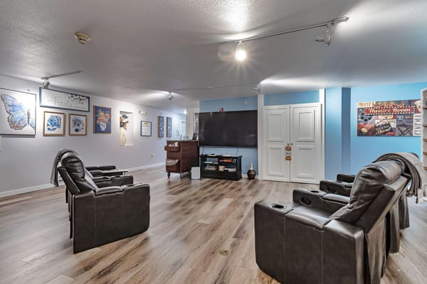Common area with recliner chairs and art on the walls