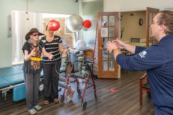 Residents participating in a fun activity with a staff member
