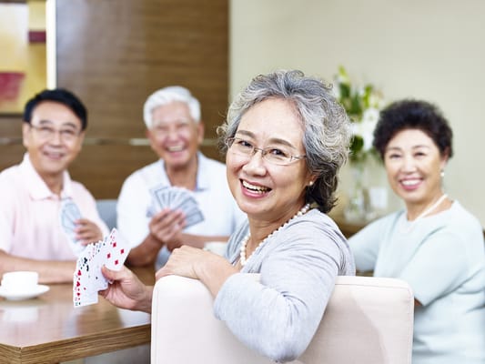 Residents enjoying a card game in a common room