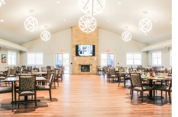 Bright and spacious dining room with tables and chairs