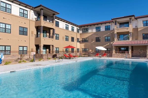 Swimming pool area with residential building in background