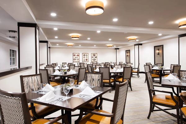 Dining area with neatly set tables and chairs