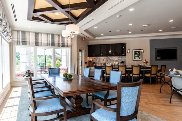 Bright common area with dining table and chairs