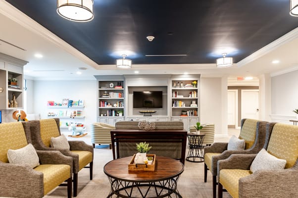 Bright common area with comfortable seating and bookshelves