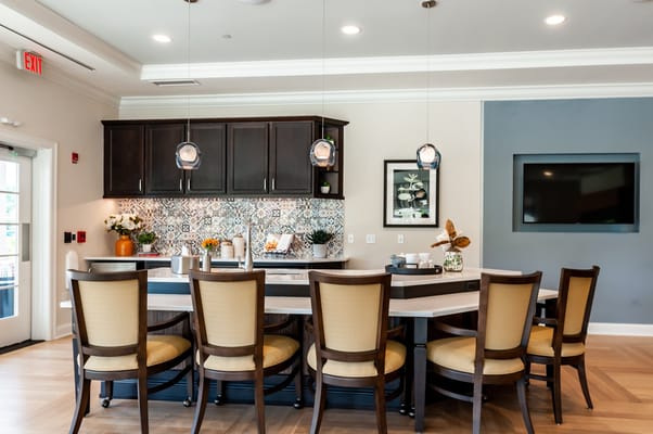 Interior common area with a kitchen bar and seating