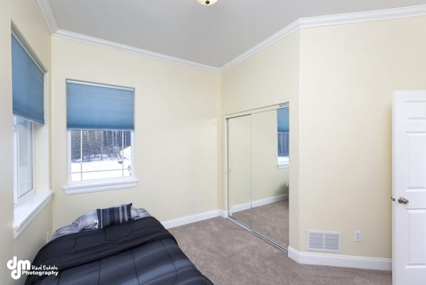 Bright, empty resident room with a bed and window