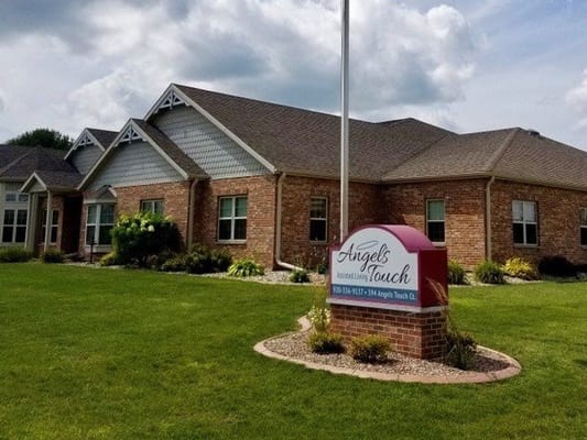 Exterior view of assisted living facility with sign