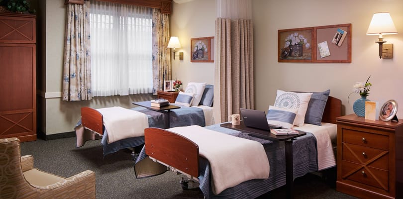 A shared resident room with two beds and decor