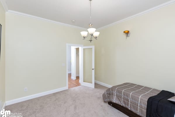 Interior view of a simple private room with a bed