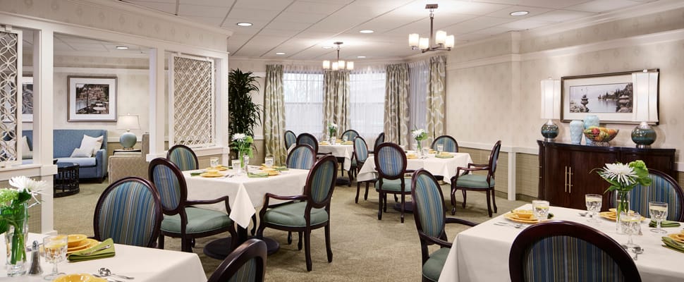 Bright dining room with tables set for a meal