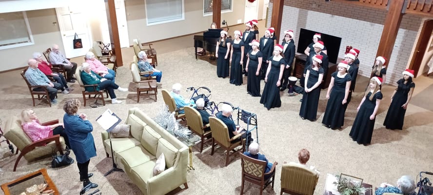 Residents enjoying a holiday performance in the common area