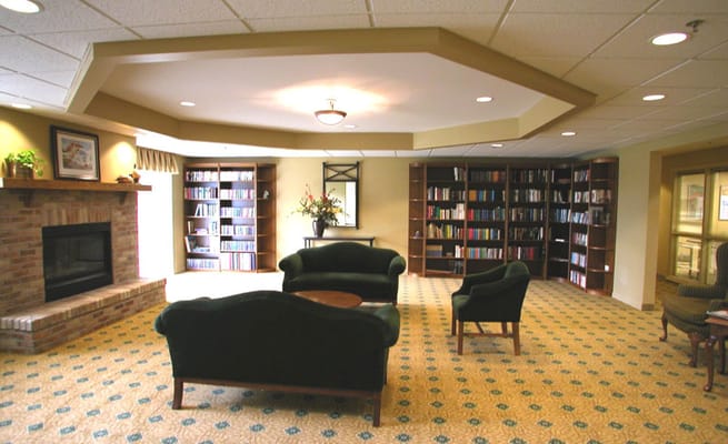 Cozy library area with bookshelves and seating