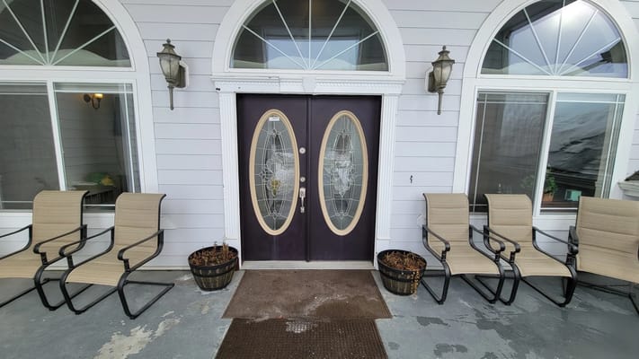 Entrance of a senior living facility with seating area