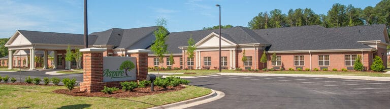 Exterior view of the assisted living facility with landscaping