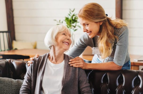Caregiver smiling and interacting with a resident