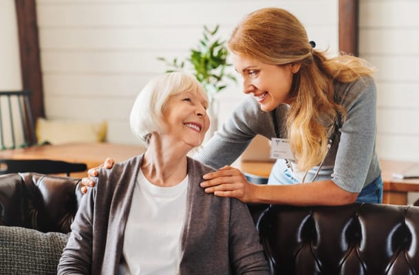 Caregiver smiling and interacting with a resident
