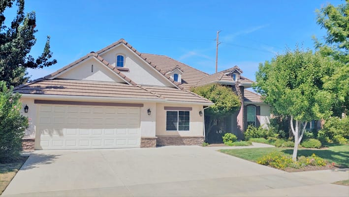 Exterior view of a single-family home with garden