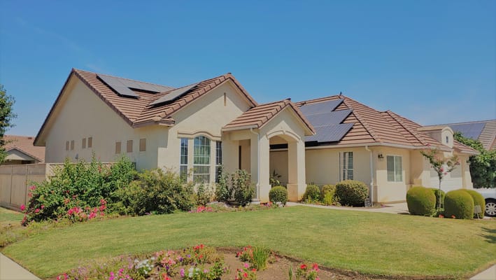 Exterior view of a senior living facility with garden