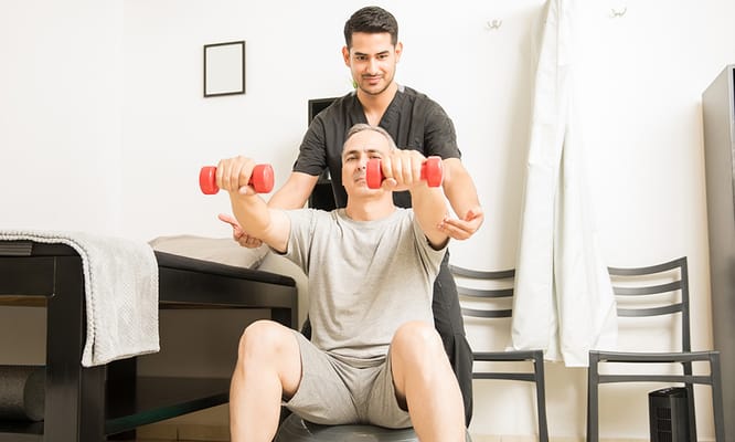 Therapist assisting a resident with weights in a training session