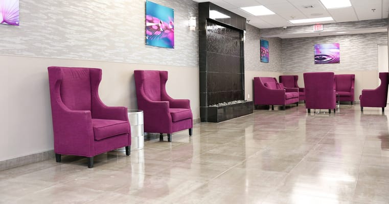 Bright common area with purple chairs and water feature