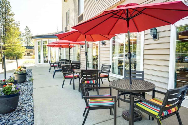 Outdoor patio area with tables and umbrellas