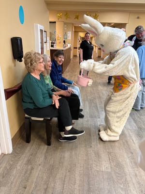 Residents enjoying an Easter event with a costumed bunny