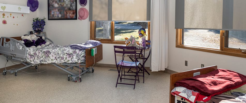 Private resident room with a hospital bed and windows