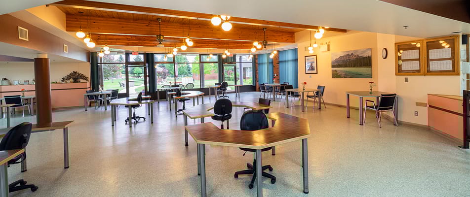 Bright and spacious common area with tables and chairs