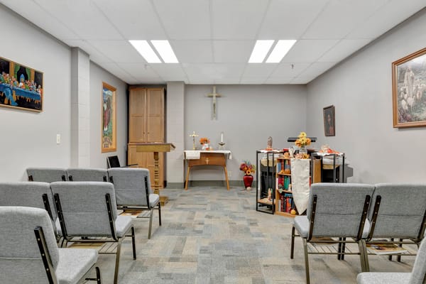 Interior chapel setting with seating and decorative altar