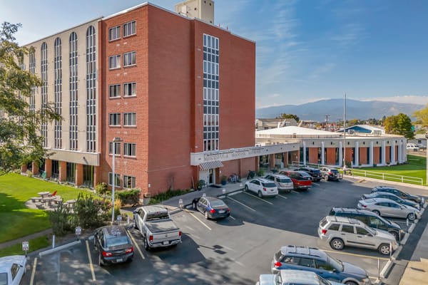 Exterior view of Missoula Manor Homes with parking lot
