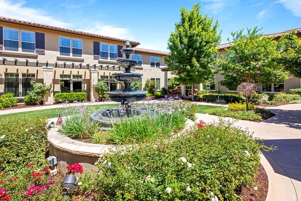 Outdoor garden area with fountain and flowers