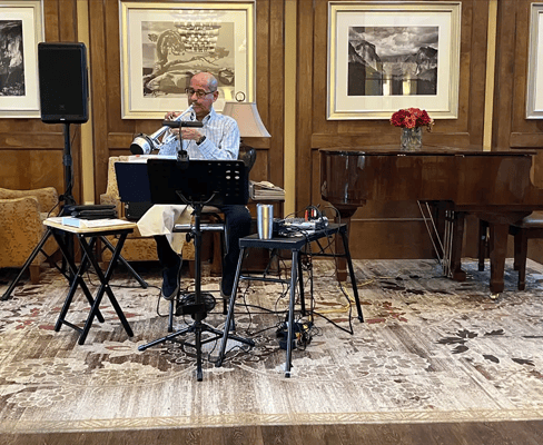 Musician performing in a cozy common area with residents