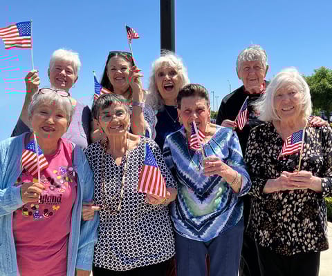 Residents celebrating with small American flags outdoors
